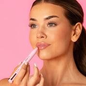 Lash Therapy Australia Model applying Lash Therapy Australia 4-in-1 makeup pen as lip liner on pink background.
