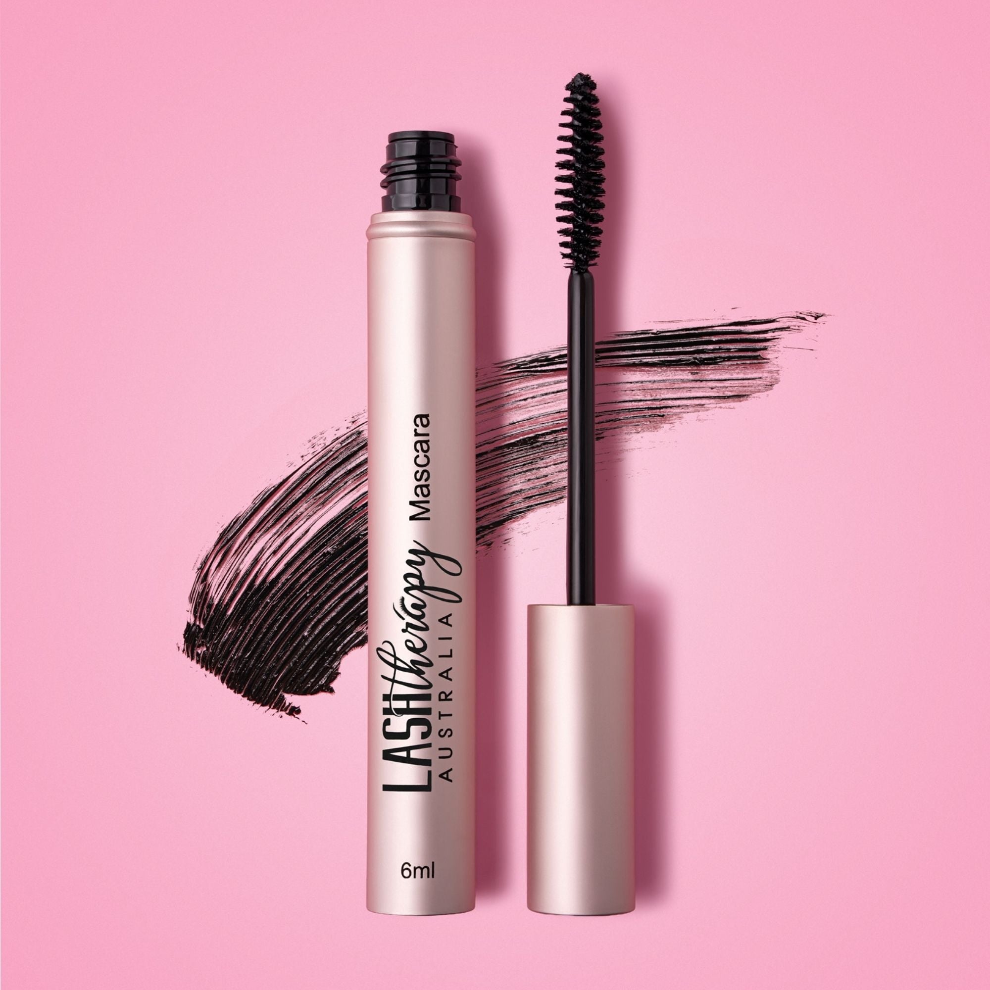 Lash Therapy Australia volumising lash growth serum mascara with mascara wand and product swatch on pink background