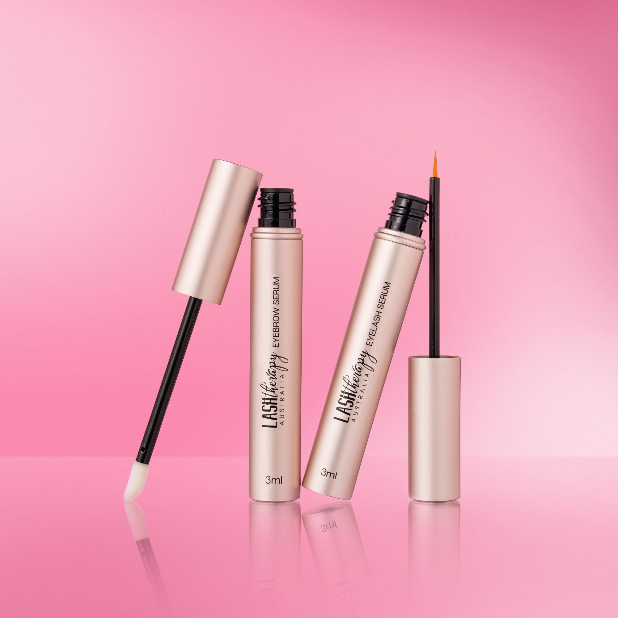 Lash Therapy Australia eyelash and eyebrow growth serums set with precision applicators on pink background.